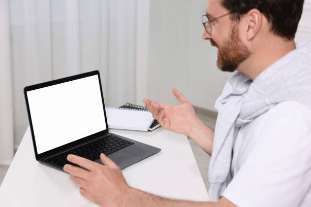 istock Man having video chat via laptop at white table indoors, selective focus 1713818263