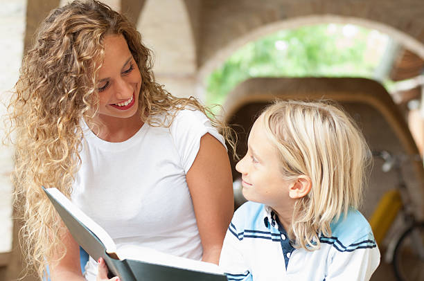 istock Girl and little boy reading a book 171382073
