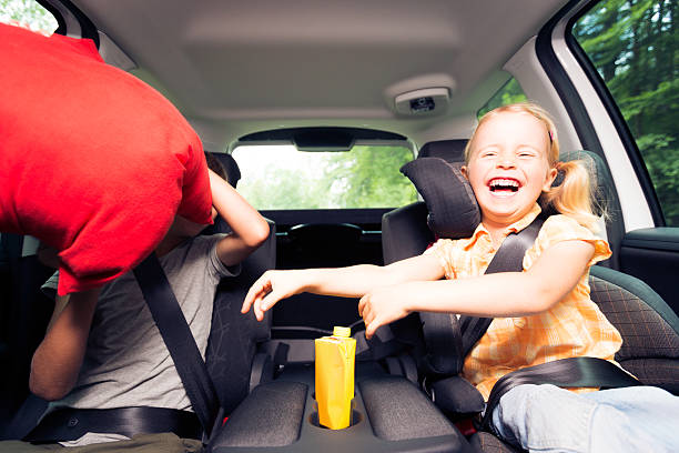 istock children sitting in the car, having a pillow fight 171382101