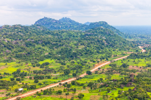 Aerial view to West African landscape with hills and roads.