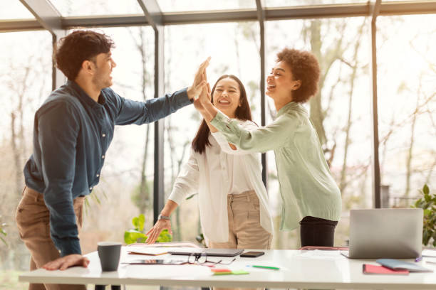 istock Three Coworkers Giving High Five Sharing Business Success In Office 1713824580