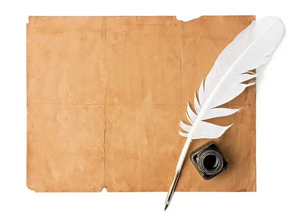 White feather quill pen and old paper on white background. Copy space for your message.