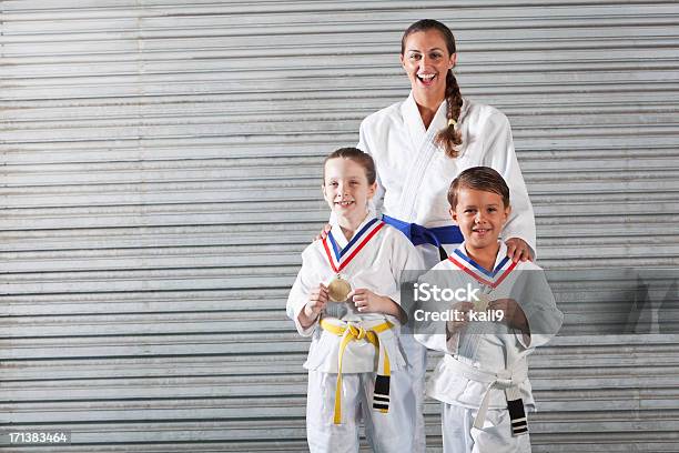 Jiujitsu Instructor And Children With Medals Stock Photo - Download Image Now - Brazilian Jiu-Jitsu, Child, 20-29 Years