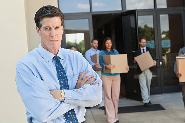 istock Angry businessman standing outside buliding after layoff 171383976