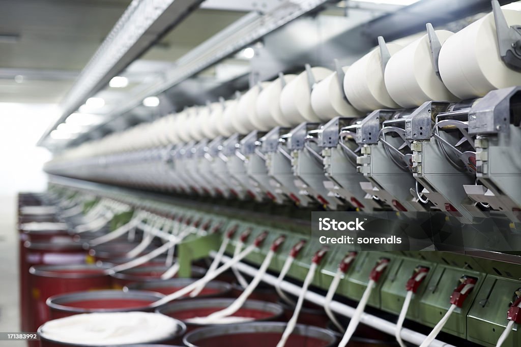 Yarn spinning machine Yarn spinning machine in a modern textile factory Cotton Mill Stock Photo