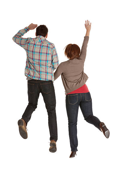 istock Rear view of a couple jumping 171384009