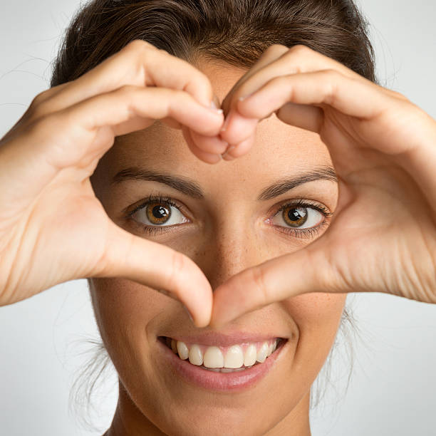 istock Beautiful woman smiling through a Finger Heart (XXXL) 171384590