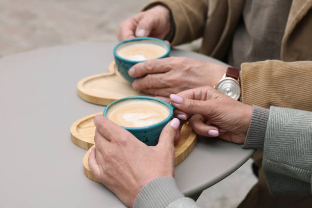istock Affectionate senior couple with coffee at table, closeup 1713847137