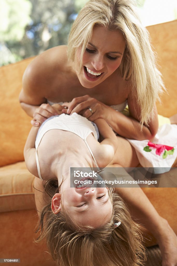 Mother And Daughter Having Fun On Sofa Mother And Daughter Having Fun On Sofa Laughing 2-3 Years Stock Photo