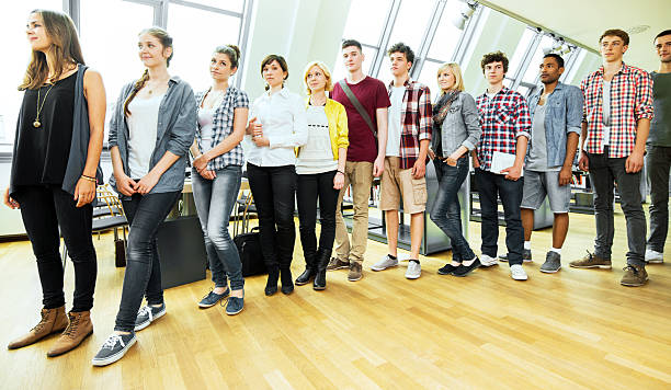 istock University students waiting in line to take books. 171384932