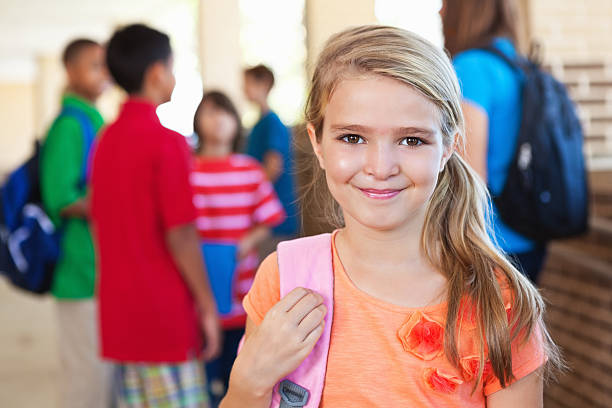 istock Happy little girl with other students outside elementary school 171385332