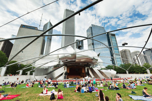 Summer Concert at the Millennium Park in Downtown Chicago "Chicago, USA - Jul 23, 2012: Concert goers gathered at the Jay Pritzker Pavilion for an outdoor summer musical performance." millennium park chicago stock pictures, royalty-free photos & images