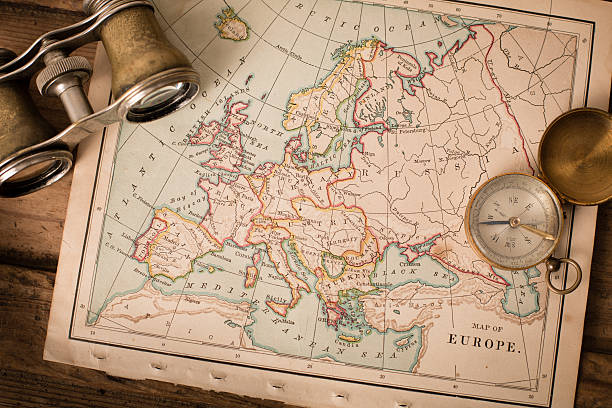 istock Antique 1870 Map of Europe, Binoculars, and Compass on Trunk 171385760