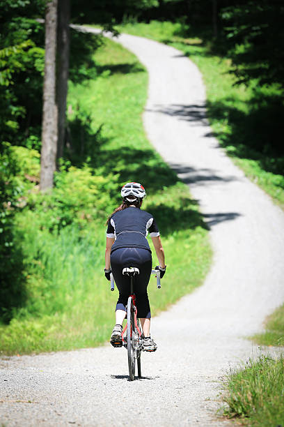istock Young Woman Cycling in Forest in Summer 171385852