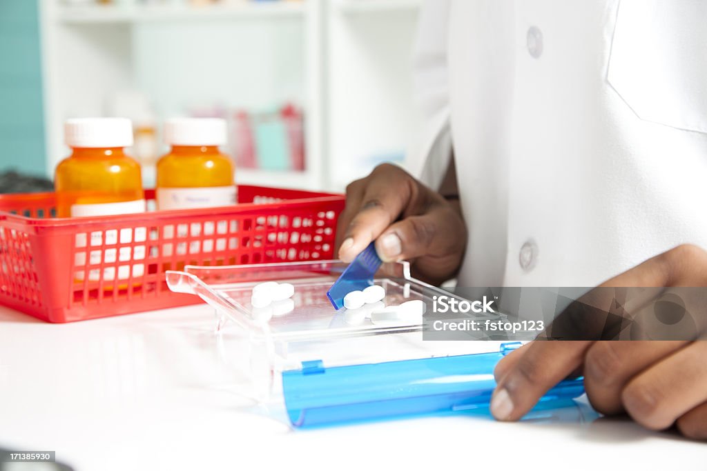 Pharmacist counting pills for a prescription. Medicine, pharmacy Pharmacist counting pills for a prescription  Generic Drug Stock Photo