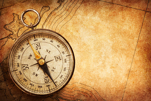 istock Compass sitting on top of old map 171385935