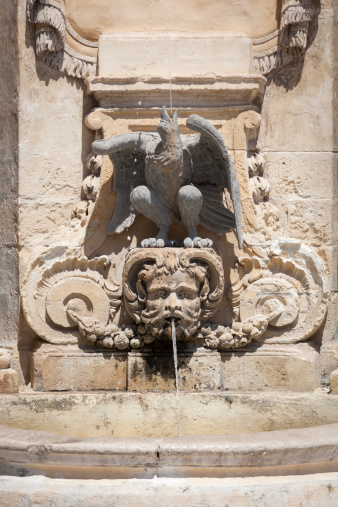 An old fountain in St George's Square, next to the Presidential Palace in Valletta, Malta.