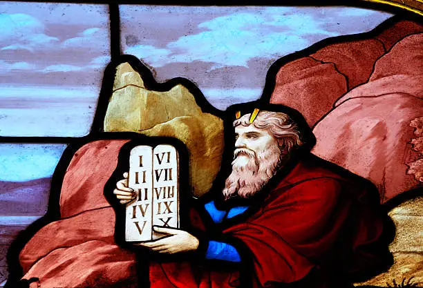 "Detail of a stained glass window form 1887 of the church Siant Aignan, Chartres. The window is made by Charles Lorin (1874 - 1940) the owner of a famous stained glass company. The window shows scenes of the old testament. This part of the woindow shows us that Moses comes down from the mountain with the tablets of law in his hand"