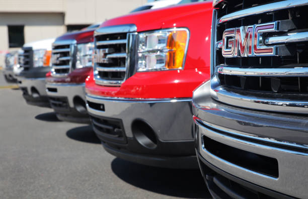 GM Trucks at Dealership "Alma, Canada- August 4, 2012: Series of brand new 2012 GMC Trucks in a local Dealership. General Motors Company, commonly known as GM, formerly incorporated (until 2009) as General Motors Corporation, is an American multinational automotive corporation headquartered in Detroit, Michigan, and the world's largest automaker, by vehicle unit sales, in 2011" buzbuzzer stock pictures, royalty-free photos & images