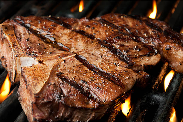 Grilled T-Bone T-Bone steak on the grill.  Please see my portfolio for other food related images. t bone steak stock pictures, royalty-free photos & images