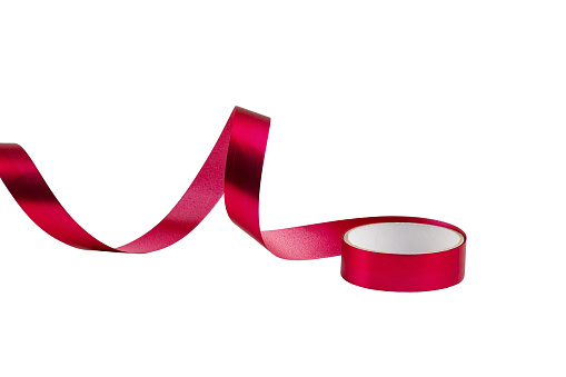 satin pink ribbon, twisted on a table, isolated on a white background