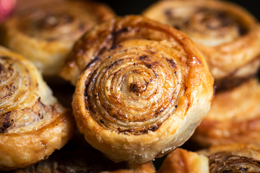 Freshly baked cinnamon buns with spices and cocoa filling, close up
