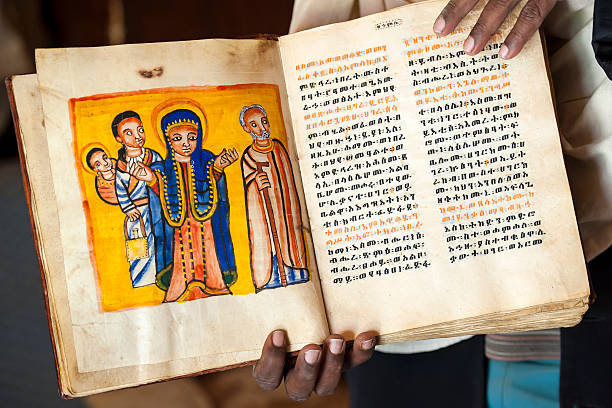 istock Priest is showing an ancient book in Ethiopia 171393831