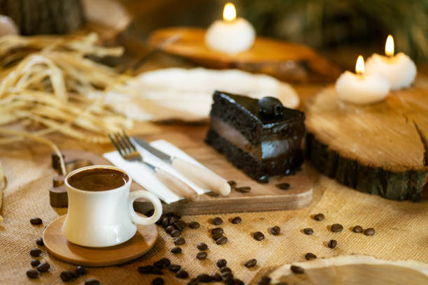 A cup of Turkish coffee takes center stage, complemented by a slice of chocolate cake, coffee beans, and ambient lighting.