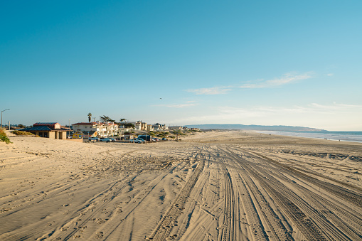 Oceano, California, USA -December 14, 2022. Tire tracks on sandy beach. Oceano Dunes Vehicular Recreational Aria, California State Park allows  vehicles to drive on the beach