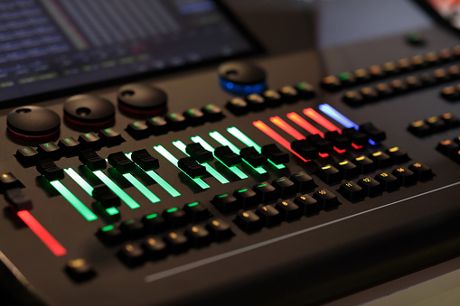 Wheels, keys and faders on the lighting control console. Selective focus.