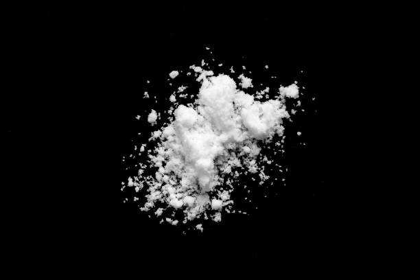 istock White snow isolated on black background close up 1714019156