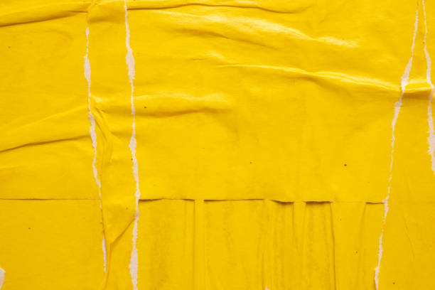 istock Old grunge ripped torn yellow paper poster surface texture background 1714021716