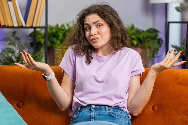 istock Confused young woman feeling embarrassed about ambiguous question, having doubts, no idea, no answer 1714022815
