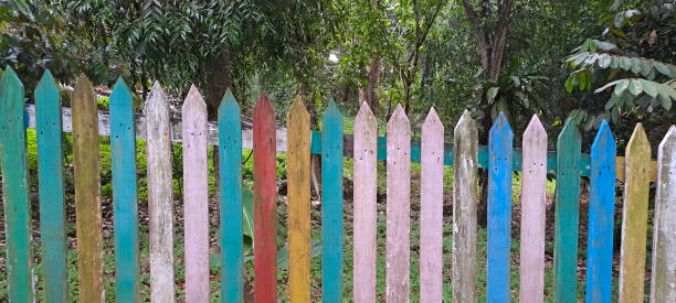 istock Multi colored rainbow wooden fence in garden background 1714028698