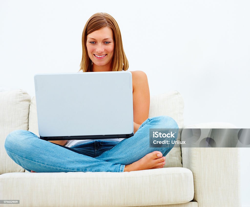 앉아 있는 여성 소파 및 노트북 컴퓨터 - 로열티 프리 노트북 스톡 사진