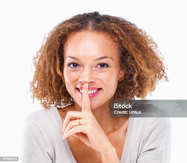 Pretty Girl With Curly Hair And Finger On Lips Isolated On White Background Stock Photo - Download Image Now