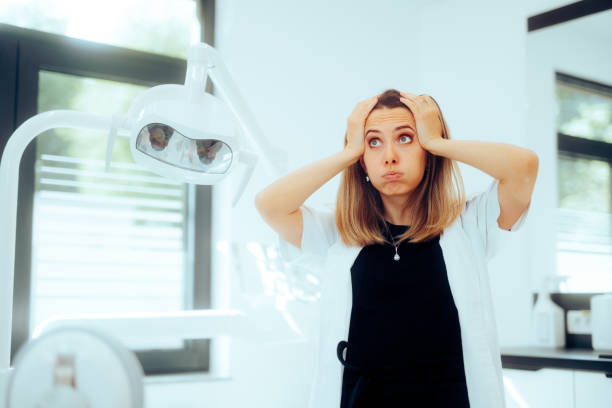 Dentiste stressée exaspérée se sentant inquiète debout dans son cabinet - Photo