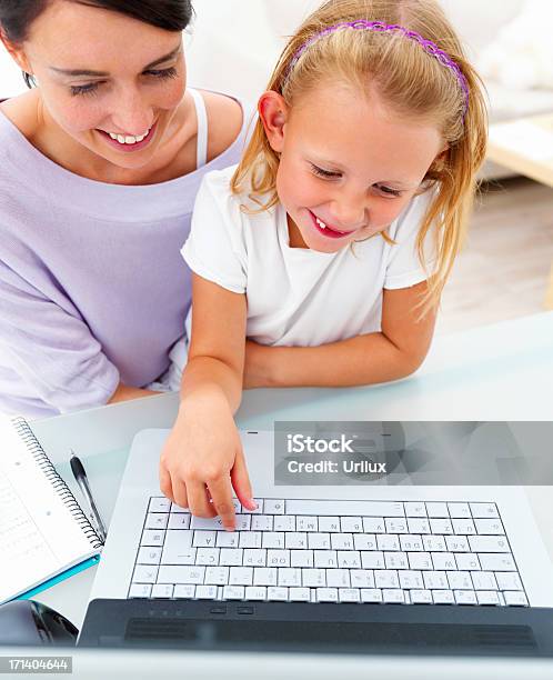 Feliz Jovem Mãe Com Sua Filha Usando Computador Portátil - Fotografias de stock e mais imagens de Adulto