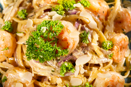 Fettuccine with shrimp and parsley - dark rustic background