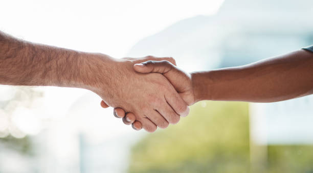 istock Help, support and handshake by men outdoor with trust, cooperation or collaboration on blurred background. People, shaking hands and friends for teamwork, thank you or partnership, deal or solidarity 1714100893