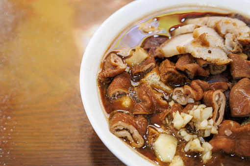 Luzhu huoshao (pork stew with bread) is one of the most well-known traditional Beijing street foods. Long considered a luxury, the cuisine is especially prevalent in Beijing. The main ingredients are pork, pork lung, pork intestines, pork liver, tofu, and some may add fermented bean curd or chives sauce. It is served with bing bread.