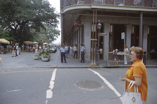 Louisiana, New Orleans, USA, 1976. Street scene with locals, tourists, police officers and buildings on Chartres St. in New Orleans.