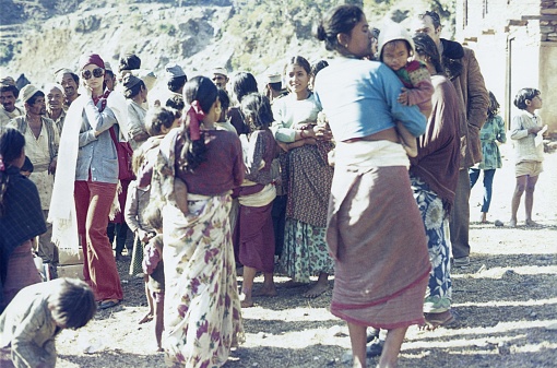 Nepal (unfortunately the exact location is not known), 1974. Nepalese look curiously at Western tourists.