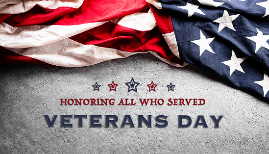 Happy Veterans day concept made from American flag and the text on dark stone background.