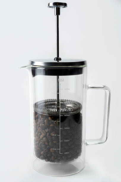 istock Coffee beans in a French press coffee maker 1714298090