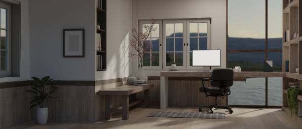 istock Modern study room with blank screen mock up desktop computer against the wall with large window. 1714305146