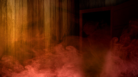 Opened door and red smoke with a wooden wall background. Scary Halloween background concept