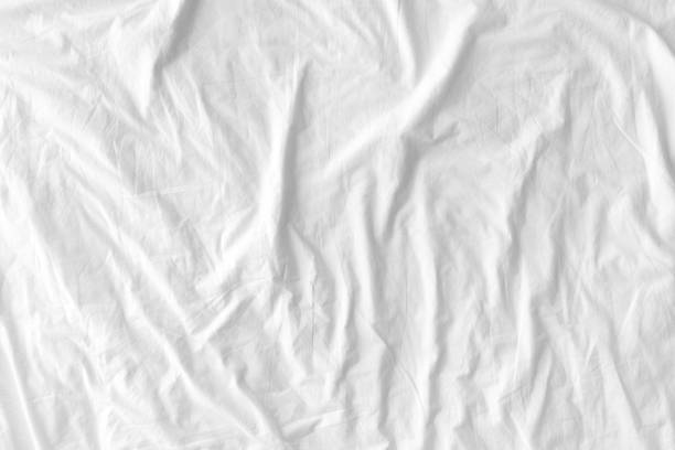 istock White wrinkled fabic texture rippled surface, Close up unmade bed sheet in the bedroom after night sleep 1714334879