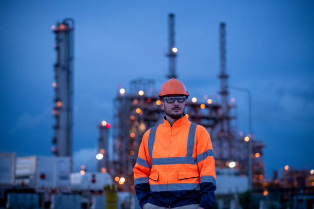 istock Engineers survey team wearing safety uniform and helmet under conversation document on hand and tablet inspect survey checking construction railway work station with oil refinery factory background 1714346798