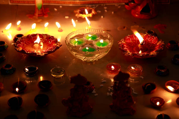 Illuminated oil lamps burning at night on Diwali festival.